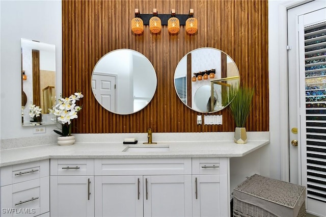 bathroom featuring vanity and wood walls