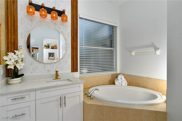 bathroom with vanity and tiled bath