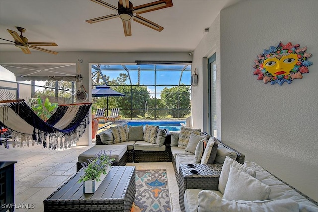 sunroom / solarium featuring ceiling fan