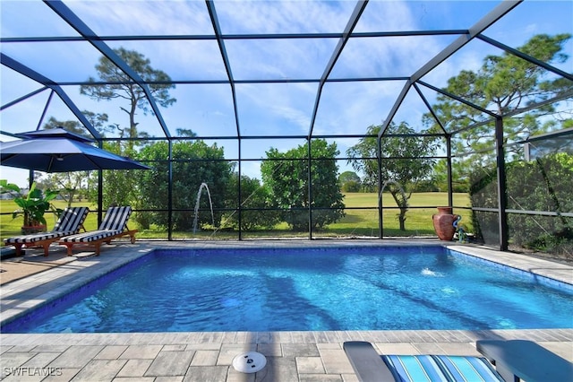 view of pool with a patio, pool water feature, and glass enclosure