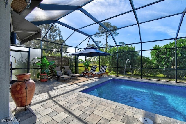 view of swimming pool featuring pool water feature, a patio, and glass enclosure