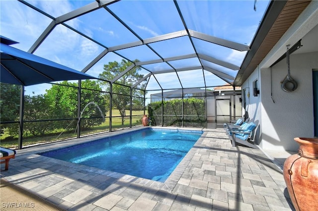 view of swimming pool with a patio and glass enclosure