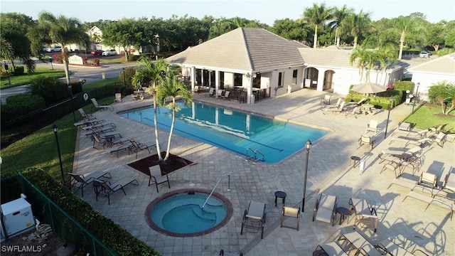 view of pool featuring a hot tub and a patio area