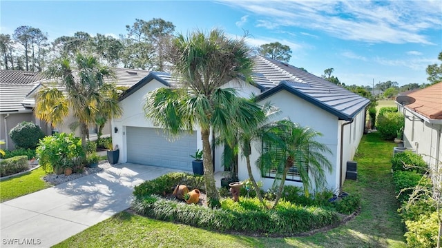 view of front of home featuring a garage and a front yard