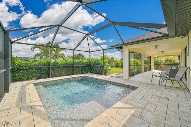 view of swimming pool featuring a lanai, ceiling fan, and a patio