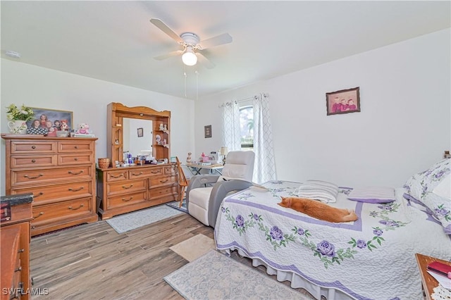 bedroom with light wood-type flooring and ceiling fan