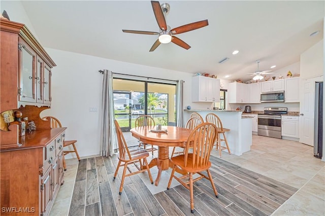 dining room with ceiling fan and lofted ceiling