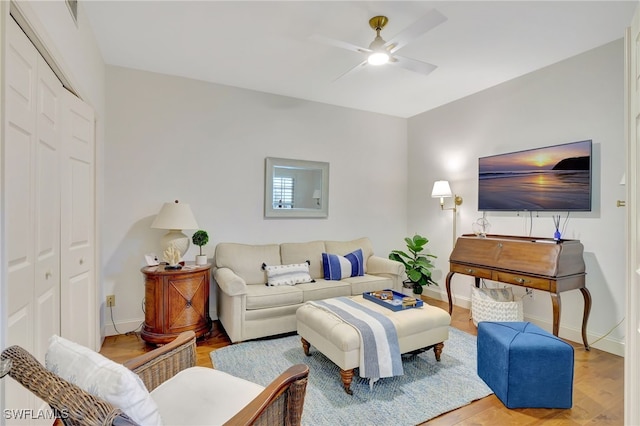 living room with ceiling fan and hardwood / wood-style floors