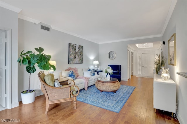 living room with ornamental molding and hardwood / wood-style floors