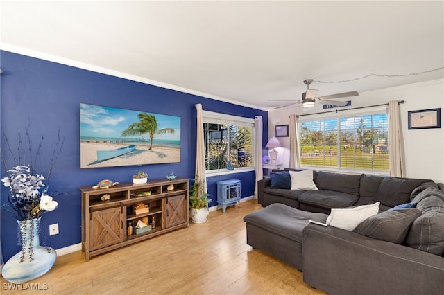 living room featuring wood-type flooring, ornamental molding, and ceiling fan