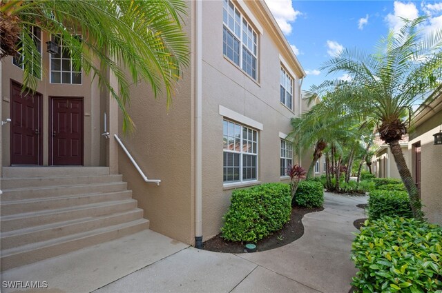 doorway to property featuring stucco siding