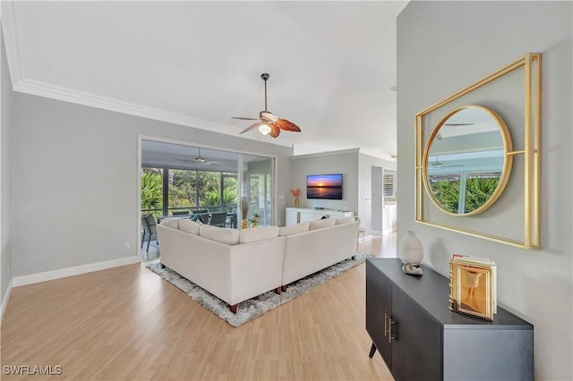 living room with crown molding and light hardwood / wood-style floors