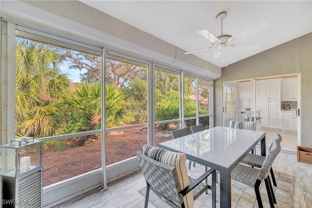 sunroom / solarium featuring ceiling fan and vaulted ceiling