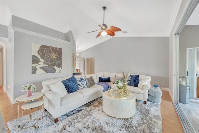 living room featuring hardwood / wood-style flooring, ceiling fan, crown molding, and vaulted ceiling