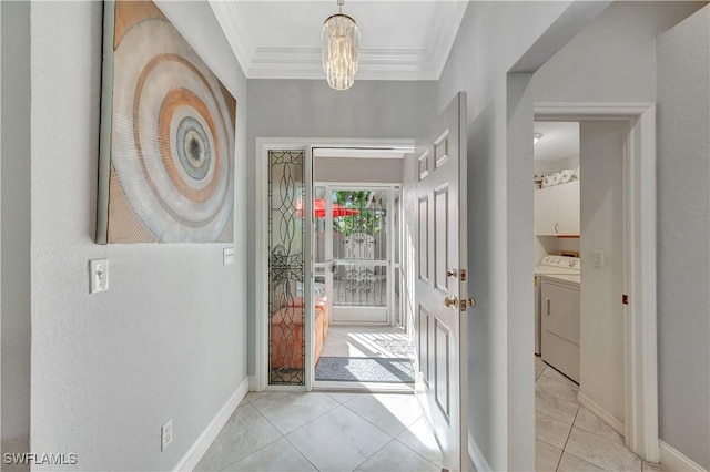 foyer featuring crown molding, washer and clothes dryer, and a notable chandelier