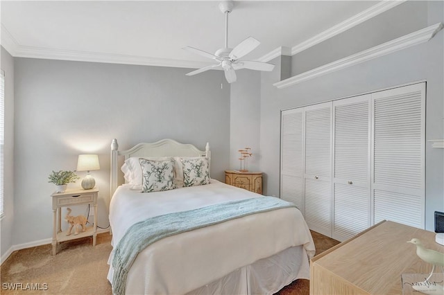 carpeted bedroom with a closet, ceiling fan, and crown molding