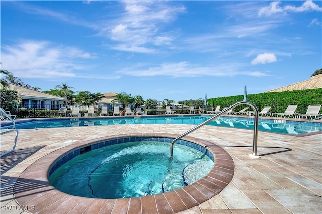 view of swimming pool featuring a community hot tub