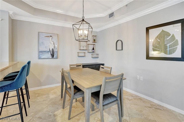 dining room with a notable chandelier, a raised ceiling, and crown molding