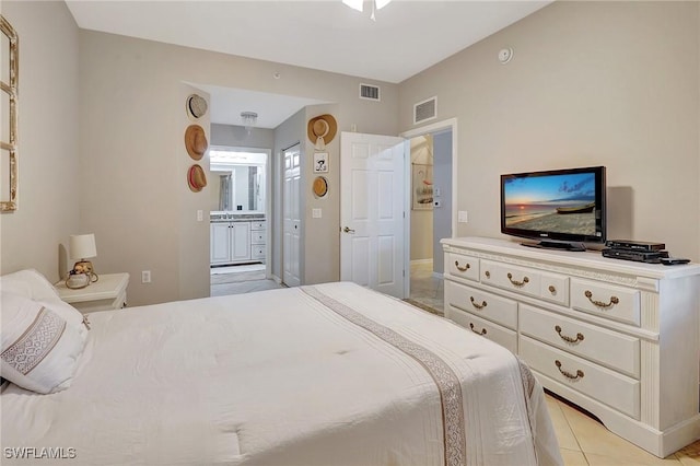 bedroom featuring light tile patterned floors and ensuite bath