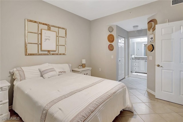 tiled bedroom featuring ensuite bathroom