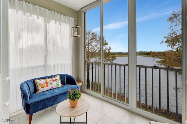 sunroom / solarium featuring a water view