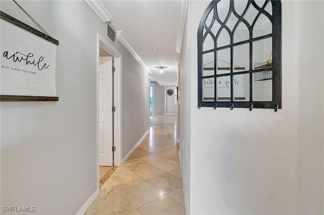 hallway featuring light tile patterned floors and ornamental molding