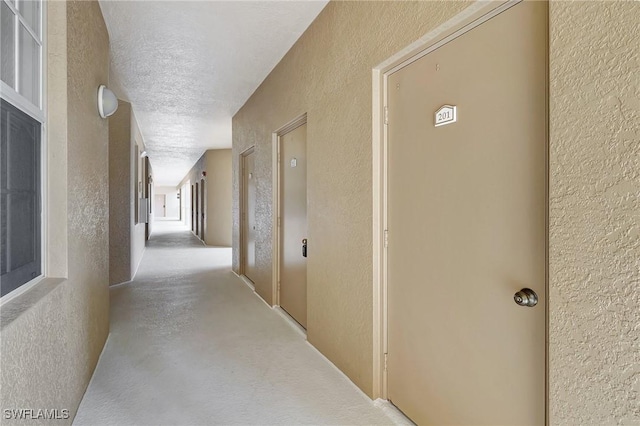 corridor with a textured ceiling