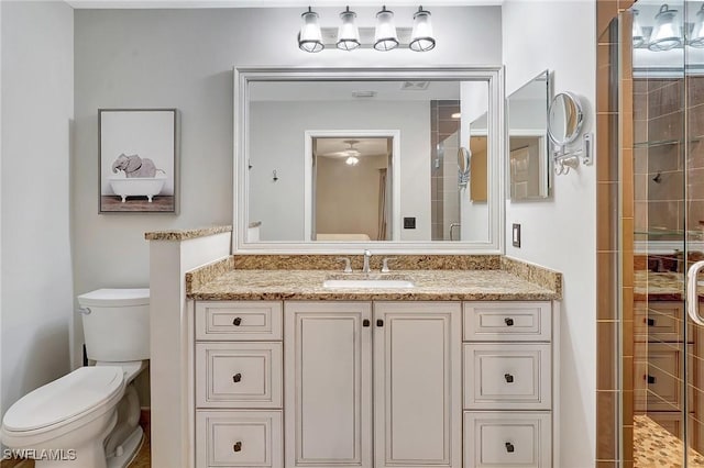 bathroom featuring vanity, toilet, and an enclosed shower