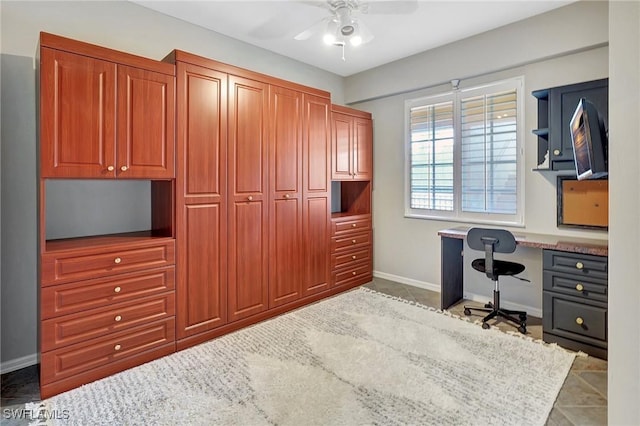 office area with ceiling fan and built in desk