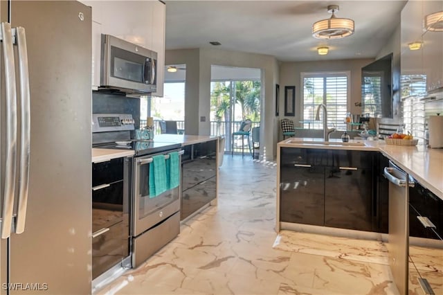 kitchen with decorative backsplash, appliances with stainless steel finishes, and sink