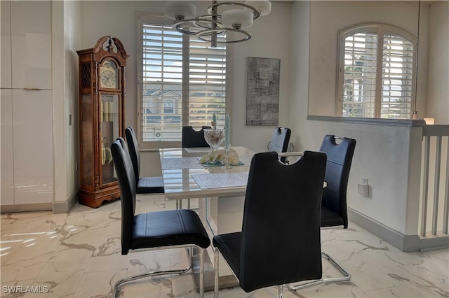 dining area with an inviting chandelier