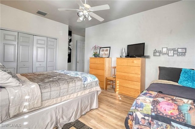 bedroom with ceiling fan, light hardwood / wood-style floors, and a closet