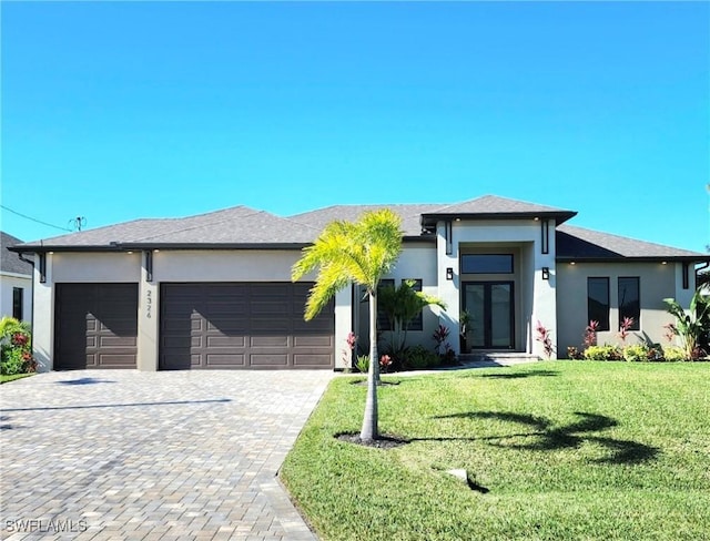 prairie-style house featuring a front yard and a garage