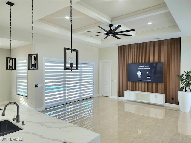 interior space featuring ceiling fan, beam ceiling, sink, and coffered ceiling