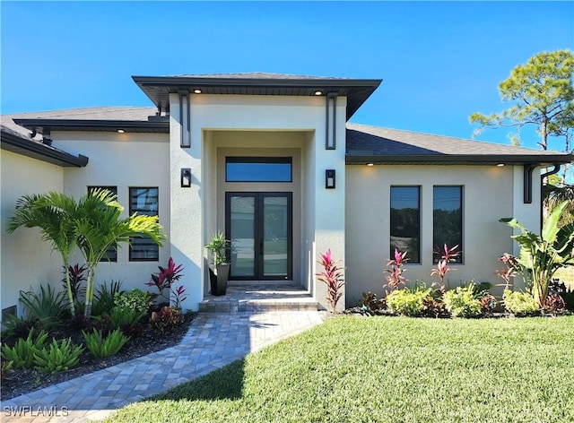 property entrance with a yard and french doors