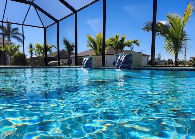 view of pool featuring a lanai and pool water feature