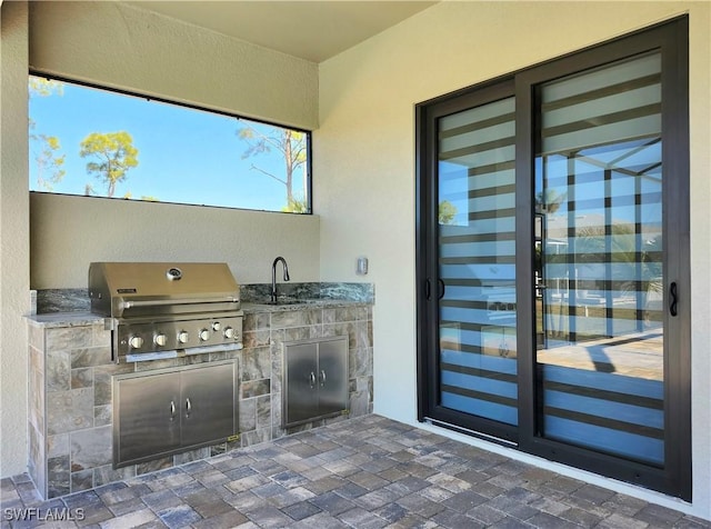 view of patio featuring area for grilling and sink