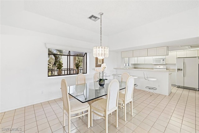 dining area featuring light tile patterned floors, visible vents, a notable chandelier, and baseboards