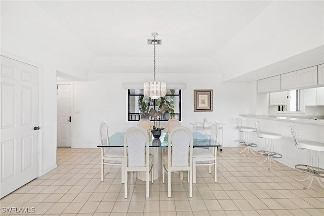 dining area with visible vents, baseboards, an inviting chandelier, light tile patterned flooring, and a raised ceiling