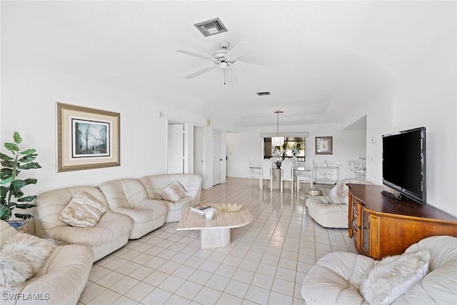 living room featuring light tile patterned floors, visible vents, and a ceiling fan