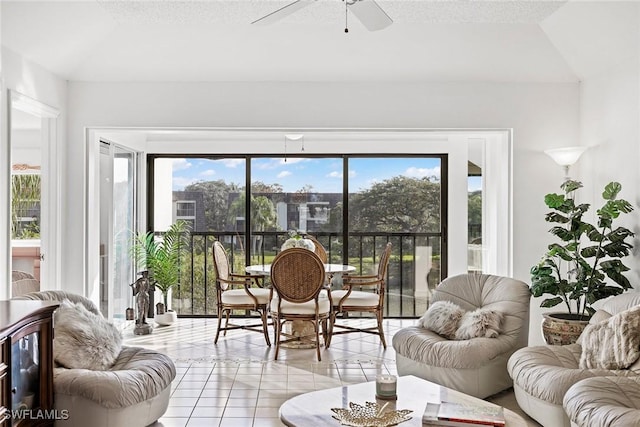 sunroom featuring ceiling fan, plenty of natural light, and vaulted ceiling