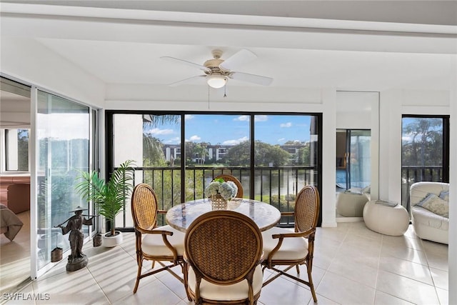 sunroom featuring ceiling fan