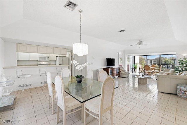 1530 Oyster Catcher Pt Unit 1530C, Naples, FL 34105 - dining space featuring light tile patterned floors, ceiling fan, and a chandelier