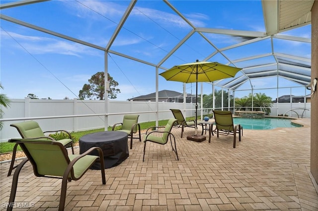 view of patio / terrace with glass enclosure, a fenced backyard, and a pool with connected hot tub