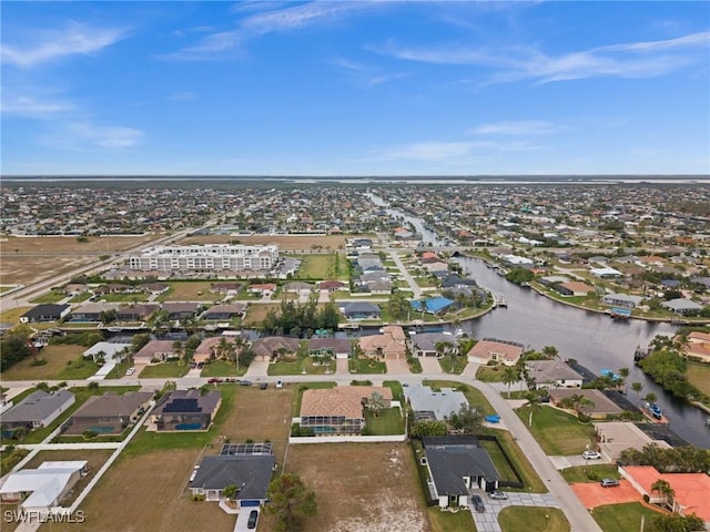 birds eye view of property featuring a residential view and a water view