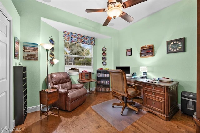 office space with wood finished floors, a ceiling fan, and baseboards