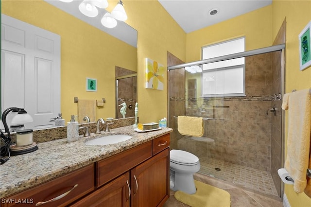 full bath featuring tile patterned flooring, toilet, a shower stall, and vanity