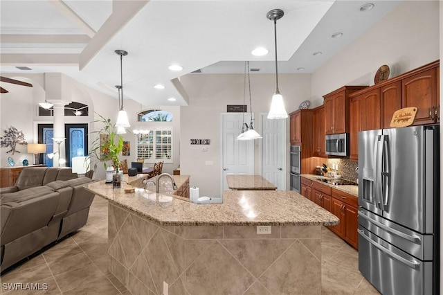 kitchen with light tile patterned floors, ornate columns, stainless steel appliances, decorative backsplash, and open floor plan