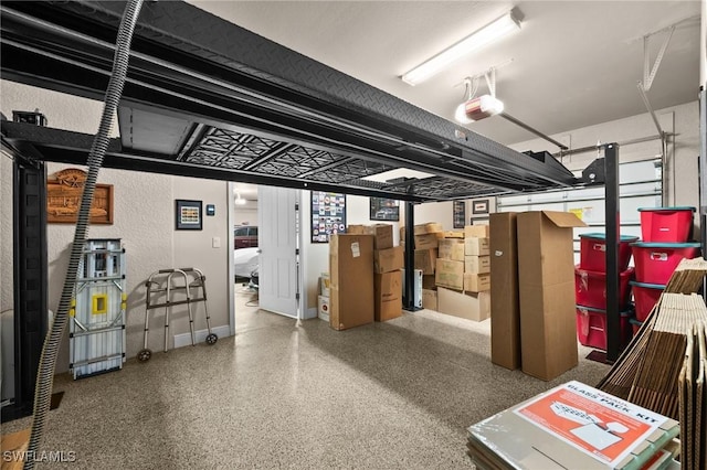 garage featuring a garage door opener and baseboards