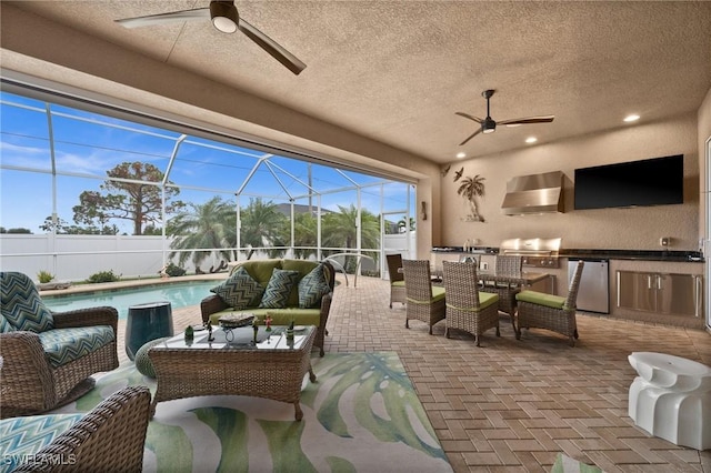 view of patio with a fenced in pool, an outdoor kitchen, an outdoor hangout area, glass enclosure, and ceiling fan